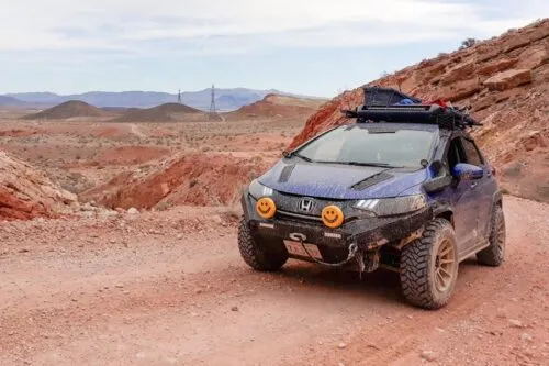 Honda offroad motorcycle riding through a dirt trail for Cashonda offroad coverage